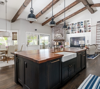 a large kitchen with stainless steel appliances and wooden cabinets